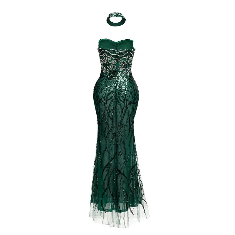 Vestido longo transparente verde-esmeralda com aplicações de ramos bordados com miçangas e choker combinando.