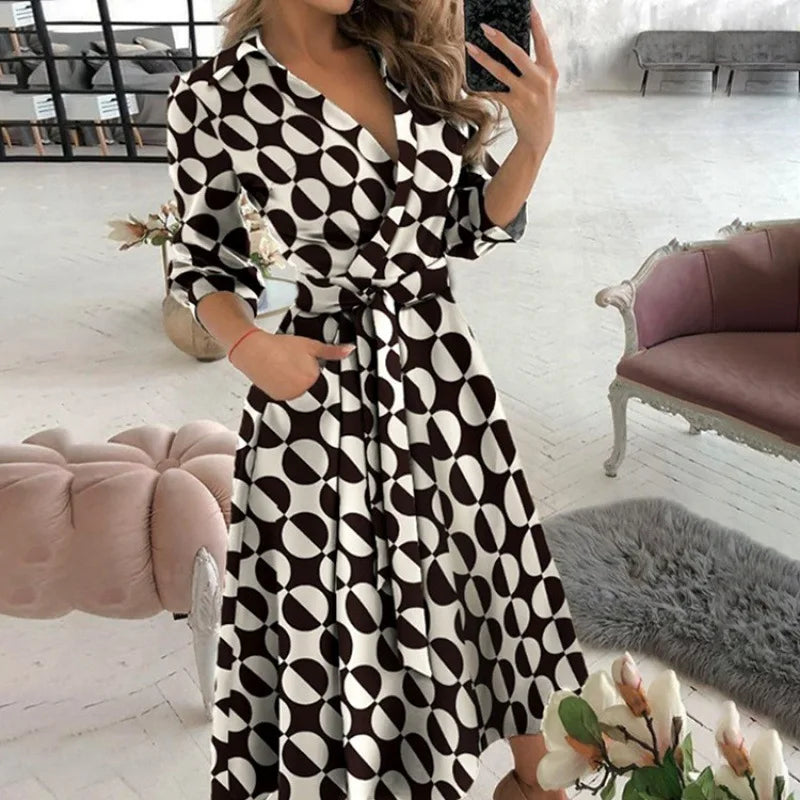 Novo vestido longo feminino de outono com estampa geométrica, decote em V, estilo camisa color block, com laço na lapela e barra assimétrica.